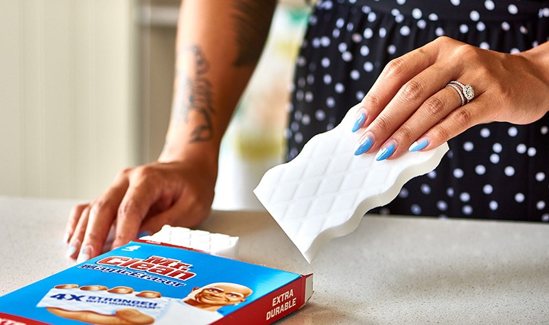 cropped picture of a man using Mr Clean Magic Eraser