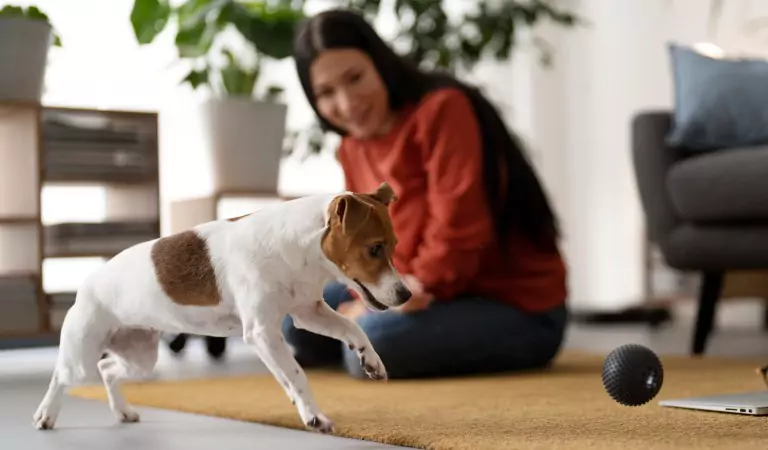 young woman with her dog inside of a house