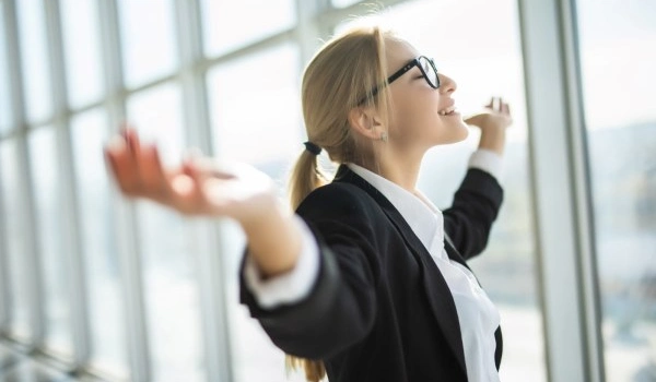 woman excited hold hands up raised and fresh breathe