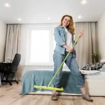 Woman posing with mop