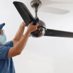 A man Cleaning Ceiling Fan